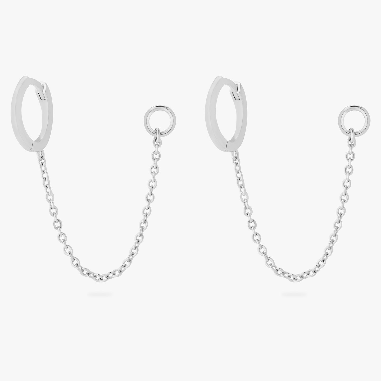 A pair of silver small slim huggies with connector chains that have a 4mm open jump ring. [pair] color:null|silver