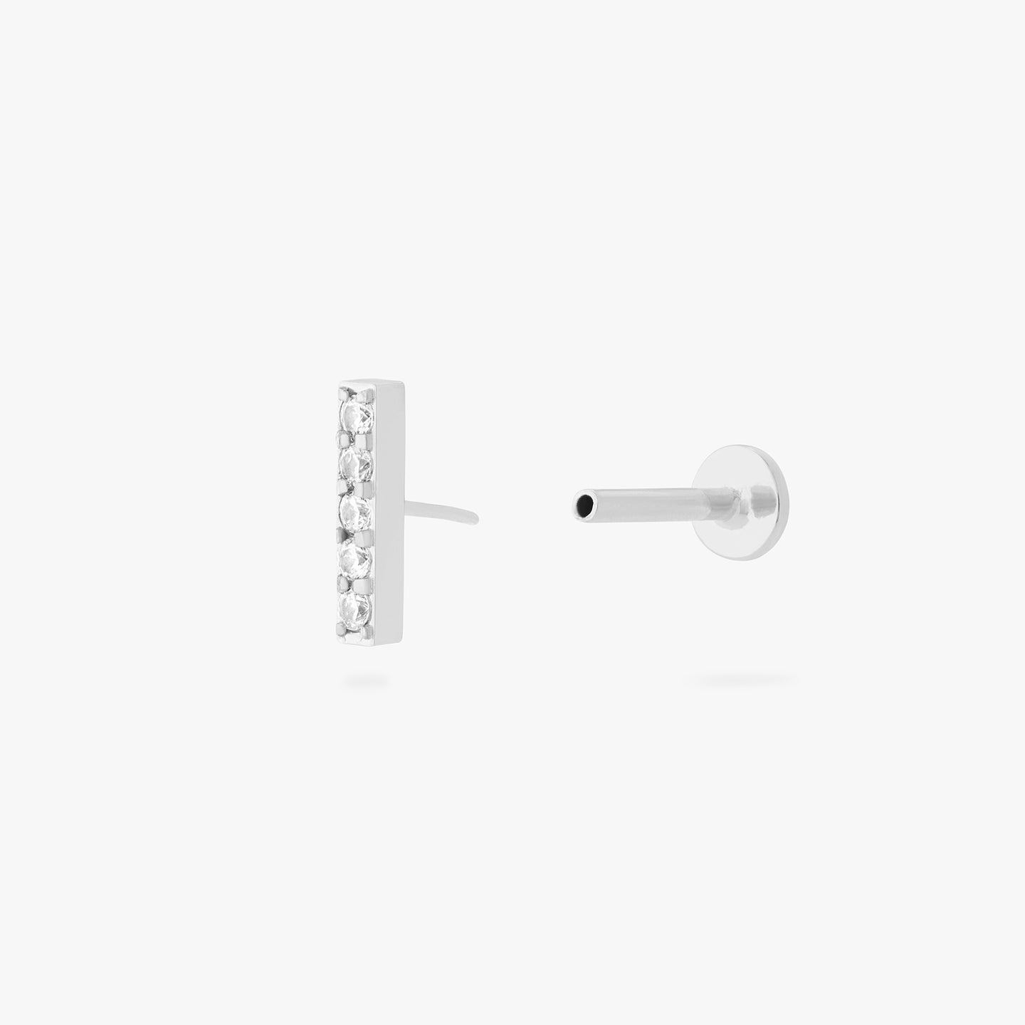 This is an image of a silver/clear bar that has 5 mini CZs in a line formation with a silver labret with a circle disc and the 