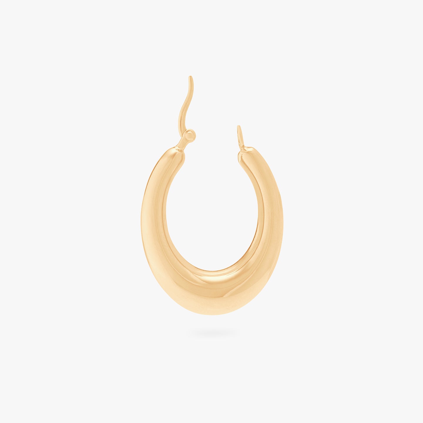 This is a gold, medium-sized, oval crescent shaped hoop unhinged. color:null|gold