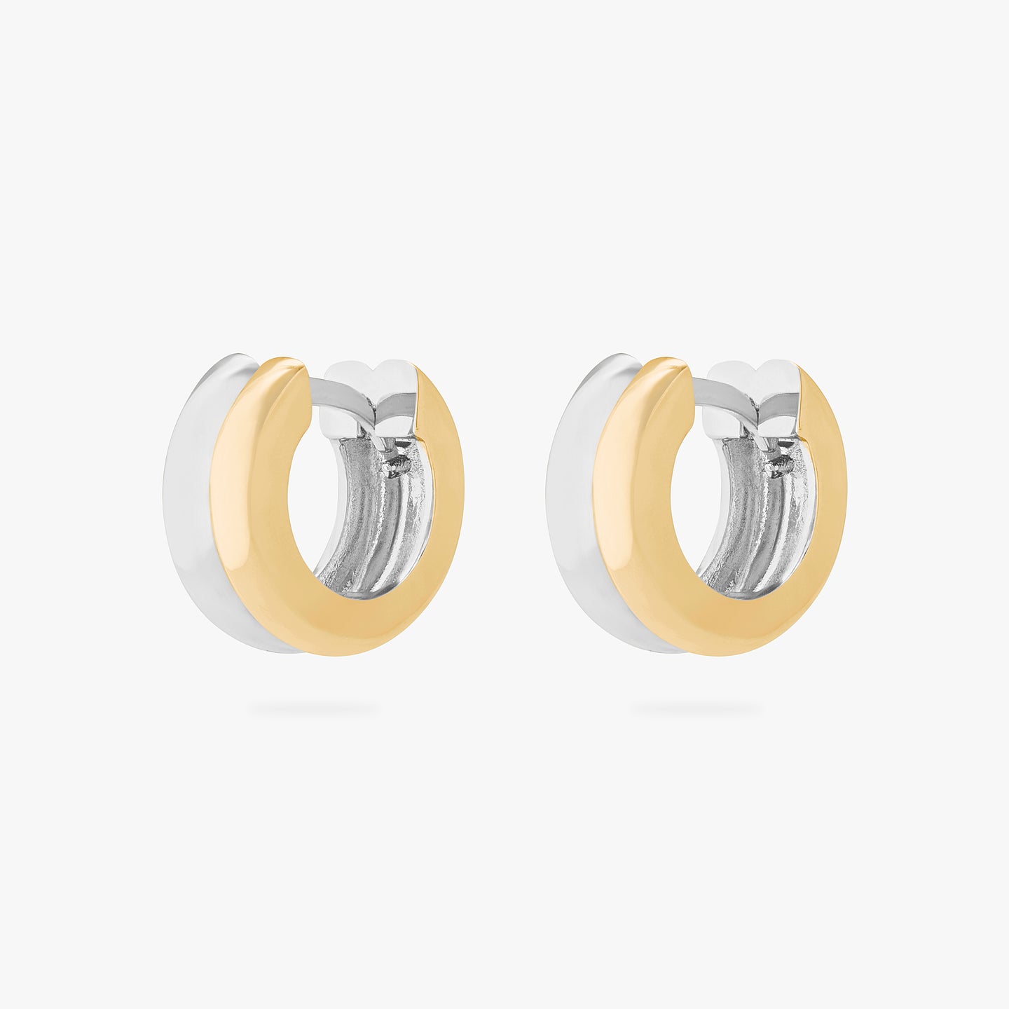 A pair of chunky huggies that are two-toned gold and silver. [pair] color:null|gold/silver