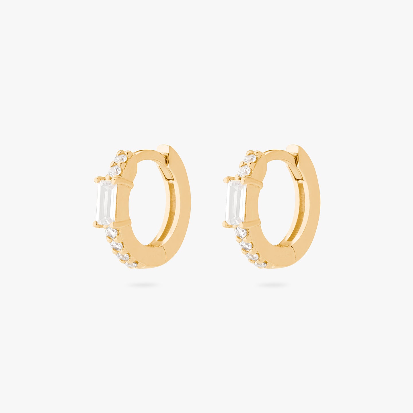 An image of a pair of gold/clear huggies with clear accent baguette CZ stones. [pair] color:null|gold/clear