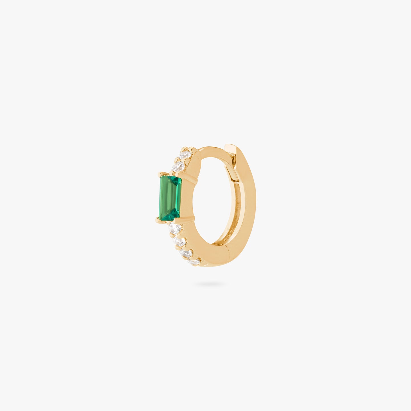 An image of a gold/clear huggie with a green accent baguette CZ stone. color:null|gold/green