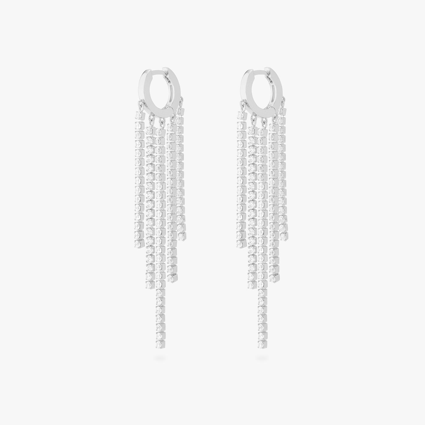This is an image of a pair of silver huggies that have silver/clear CZ strands dangling from them in a fringed pattern. [pair] color:null|silver/clear