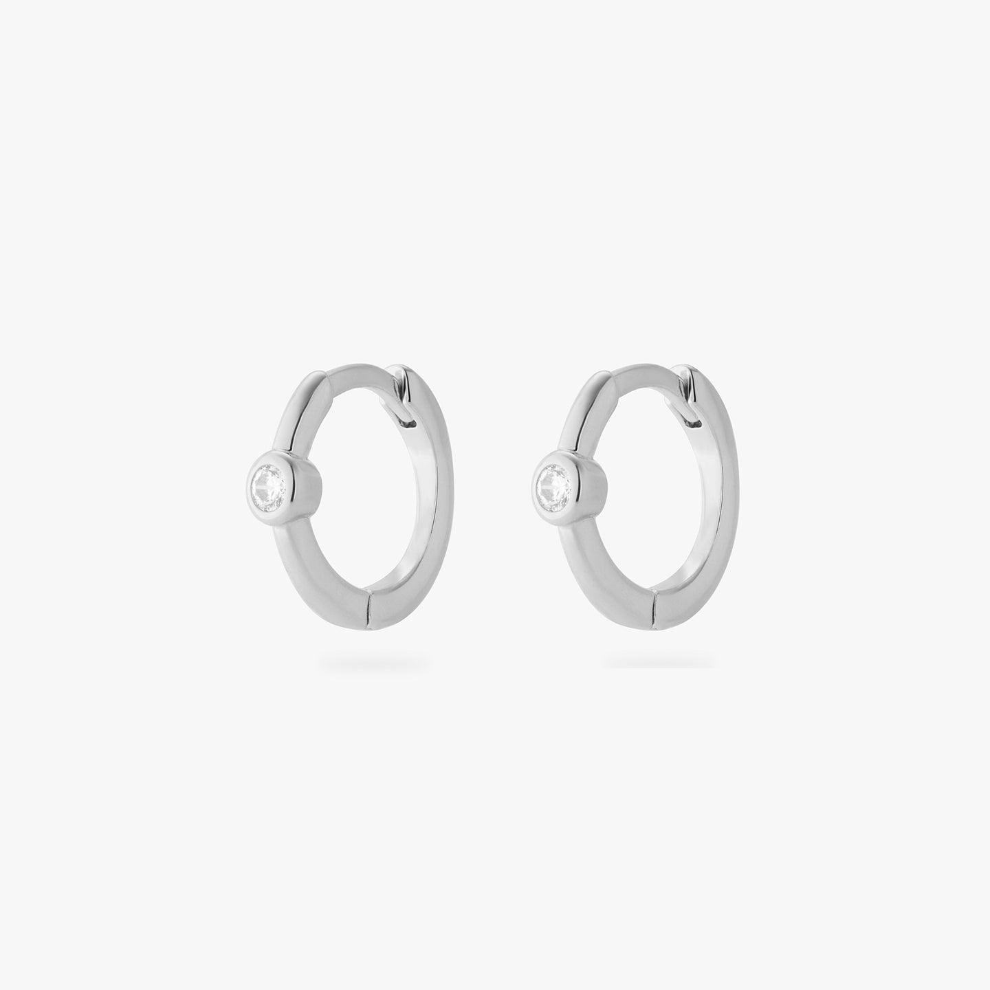a pair of silver small slim huggies with clear cz bezels [pair] color:null|silver/clear