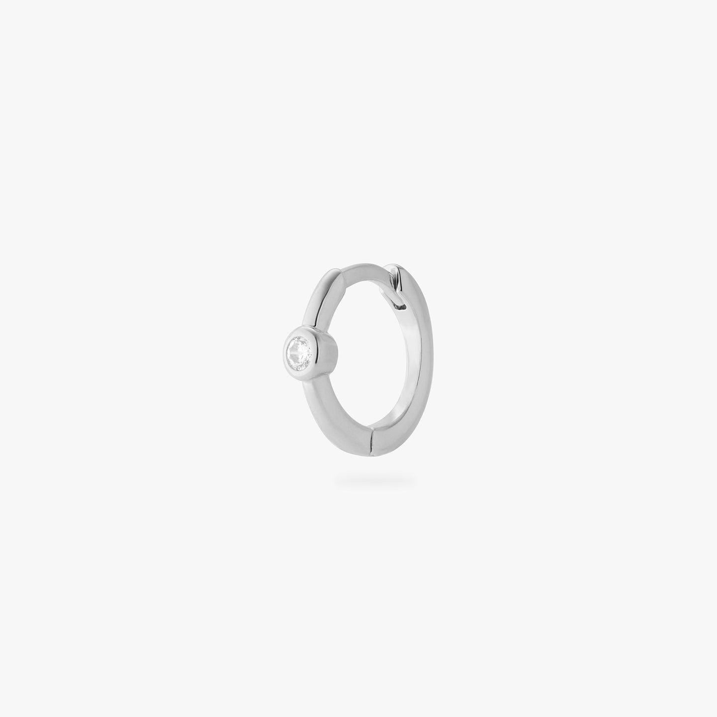 a silver small slim huggie with a clear cz bezel color:null|silver/clear