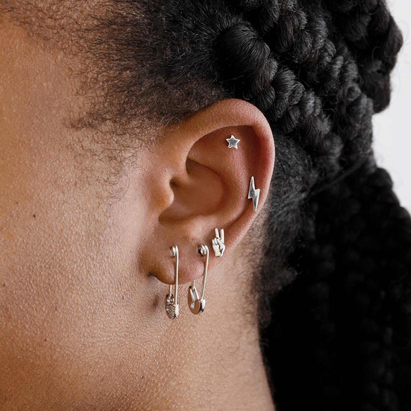 This is a small silver safety pin earring with pavé detail on the tip [hover] color:null|silver/clear