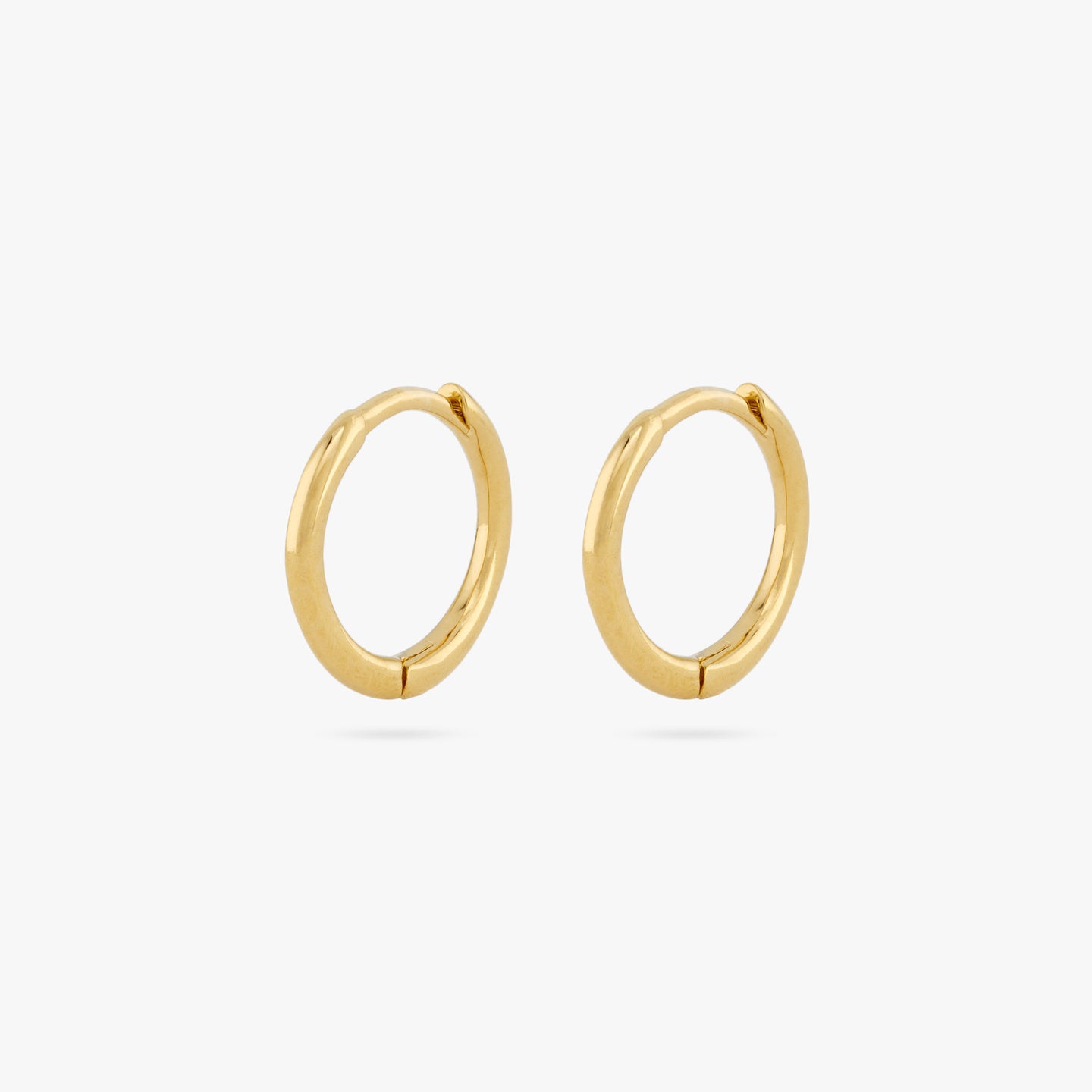 pair of small slim gold huggies. [pair] color:null|gold