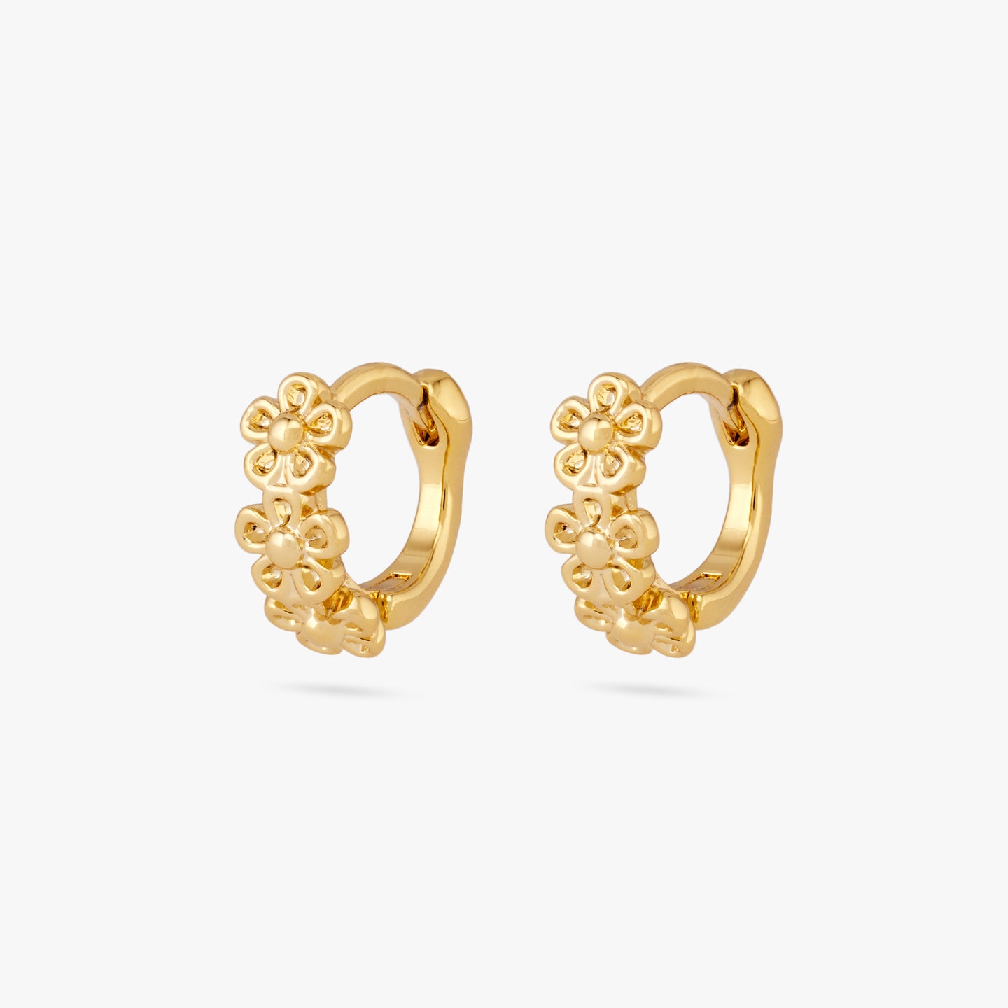 This is a pair of three small gold daisy-shaped flowers on micro huggies [pair] color:null|gold