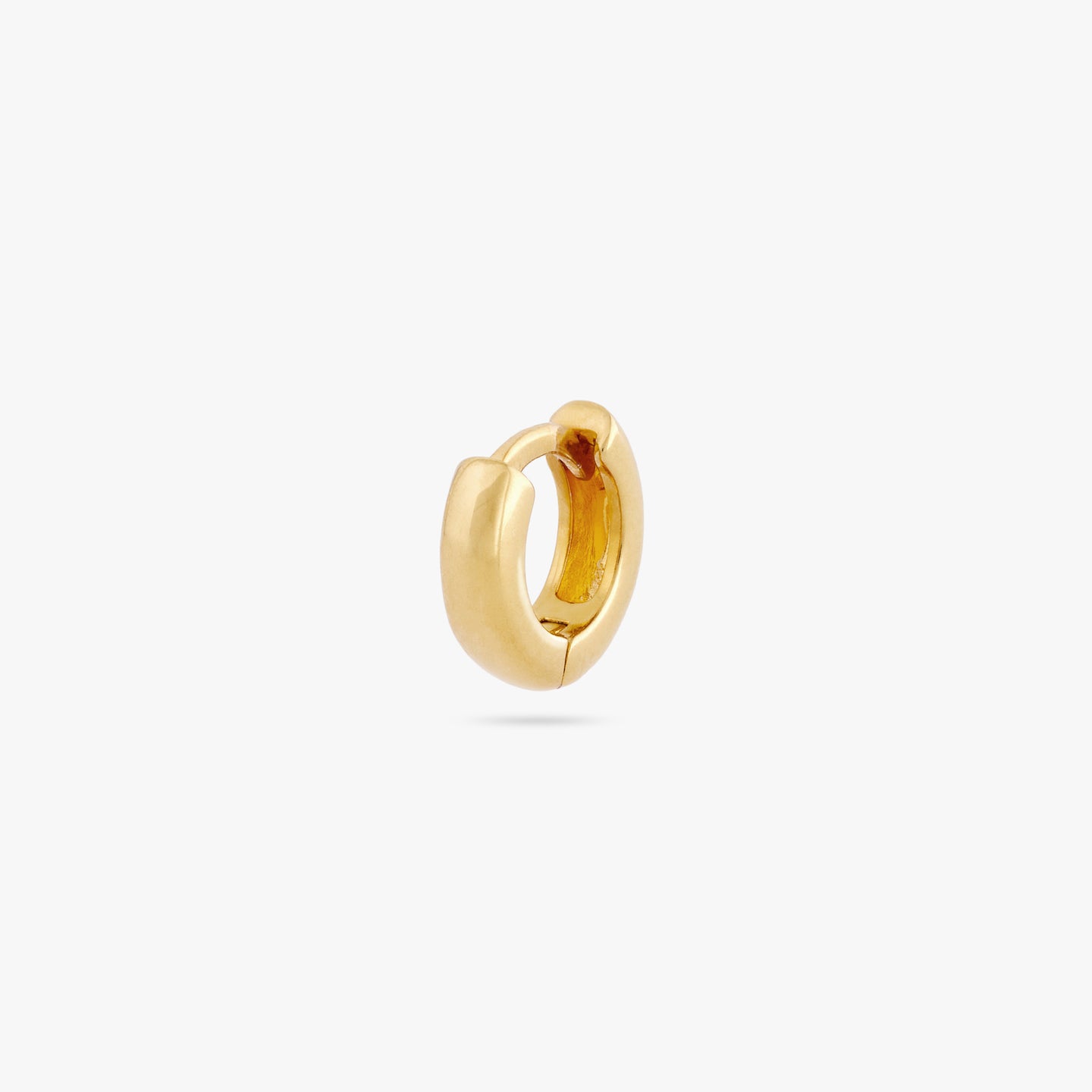 Micro sized chunky gold huggie. color:null|gold