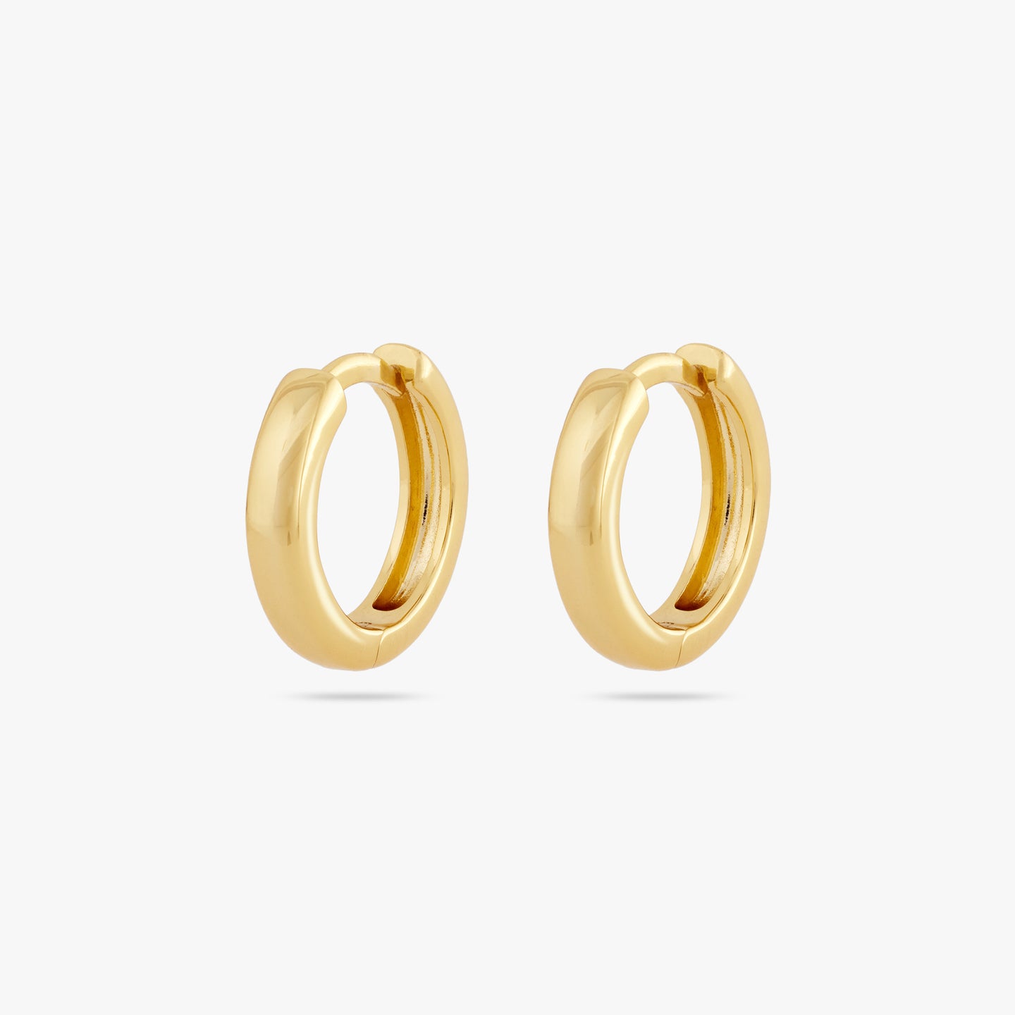 A pair of small bulky and chunky shaped gold huggies [pair] color:null|gold