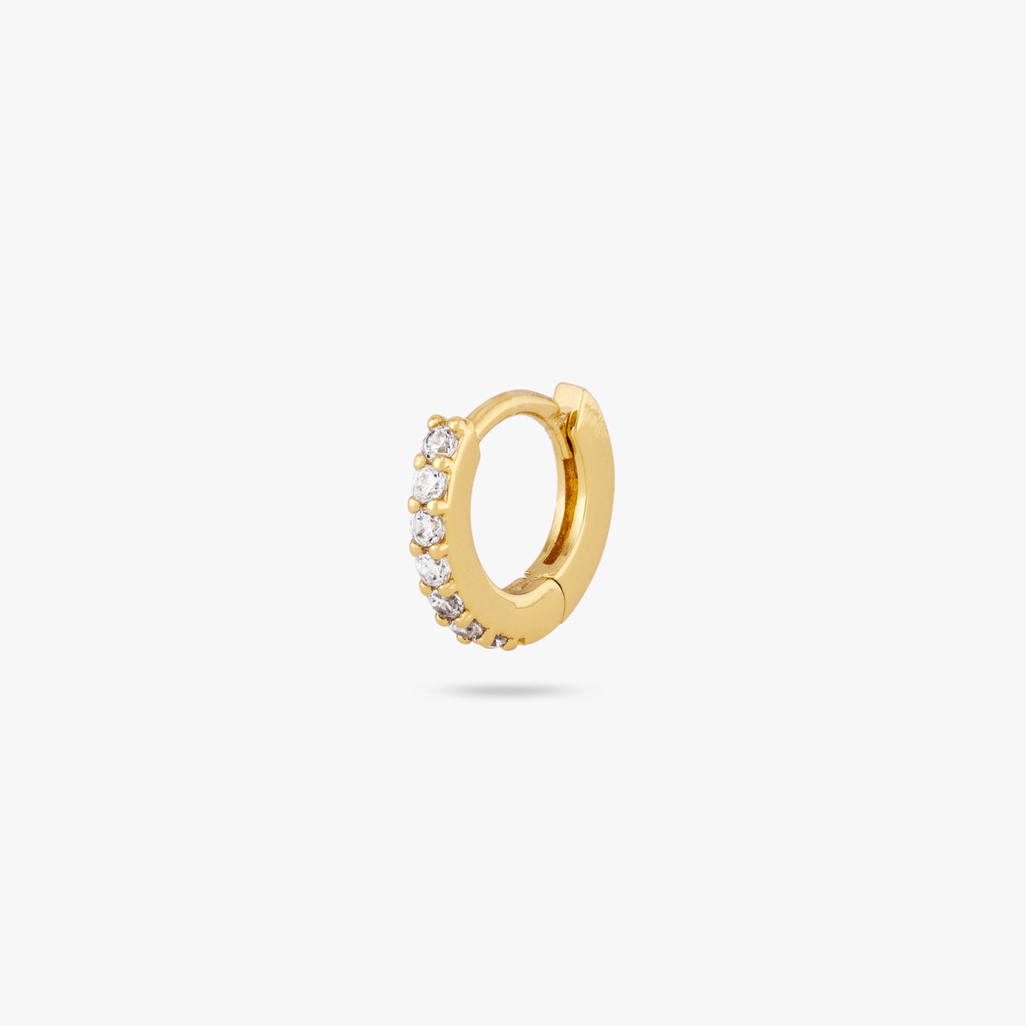 A clear/gold micro pave huggie with a 6mm inner diameter color:null|gold/clear