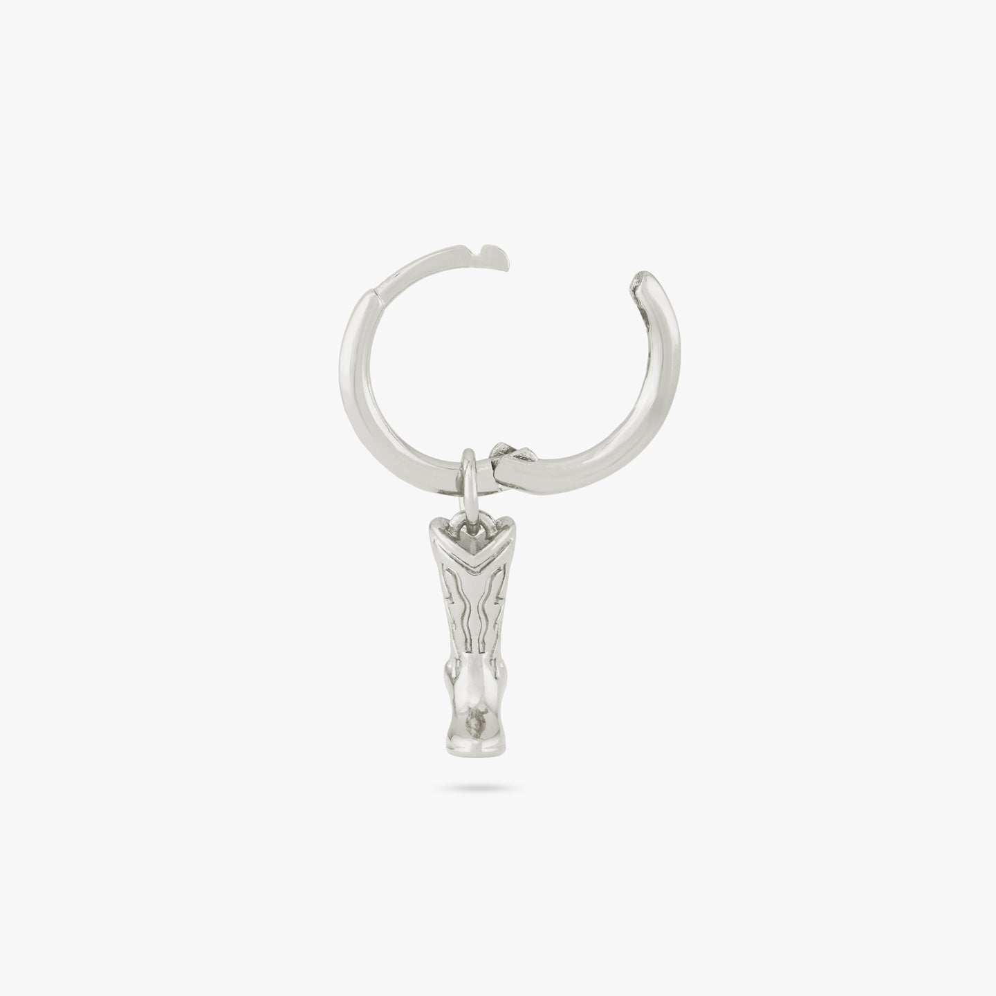 This is a silver cowboy boot charm dangling from a silver huggie and the clasp is undone color:null|silver