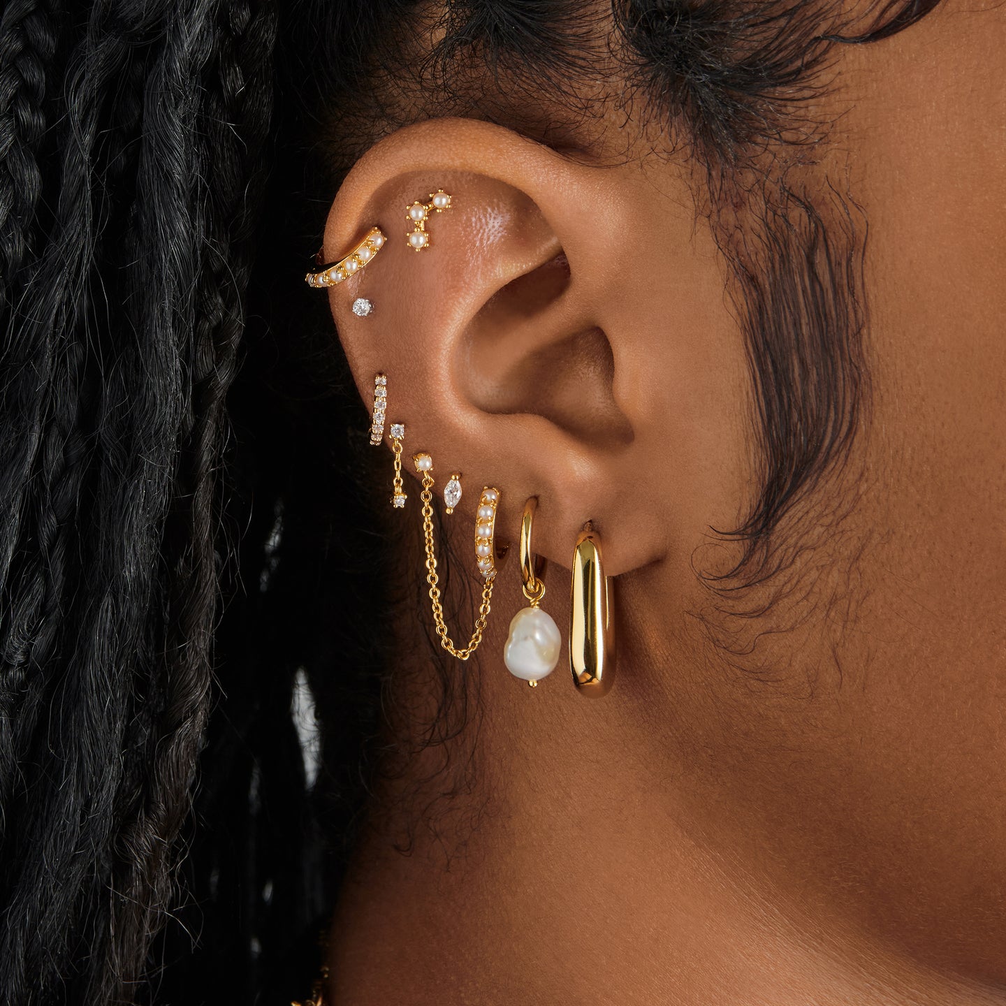 A clear/gold micro pave huggie with a 6mm inner diameter on ear [hover] color:null|gold/clear