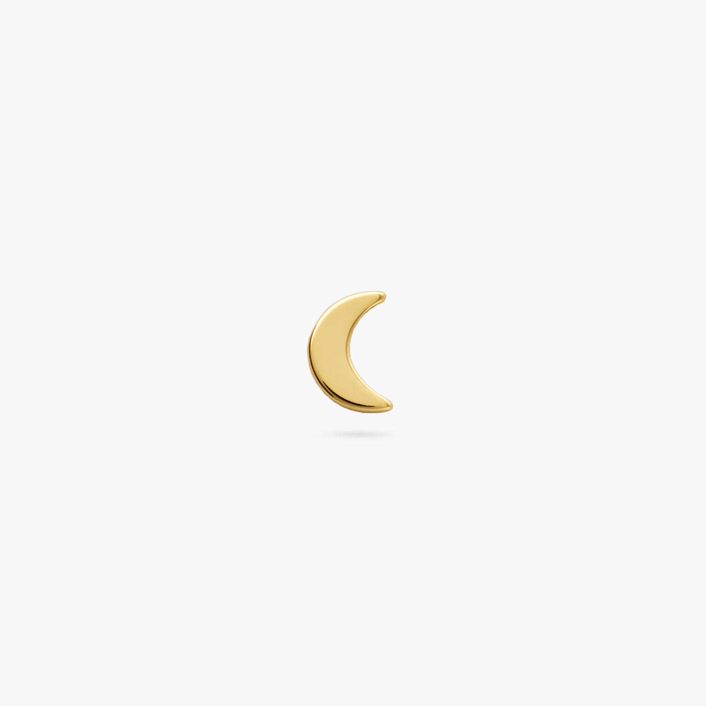 A gold small moon shaped stud color:null|gold
