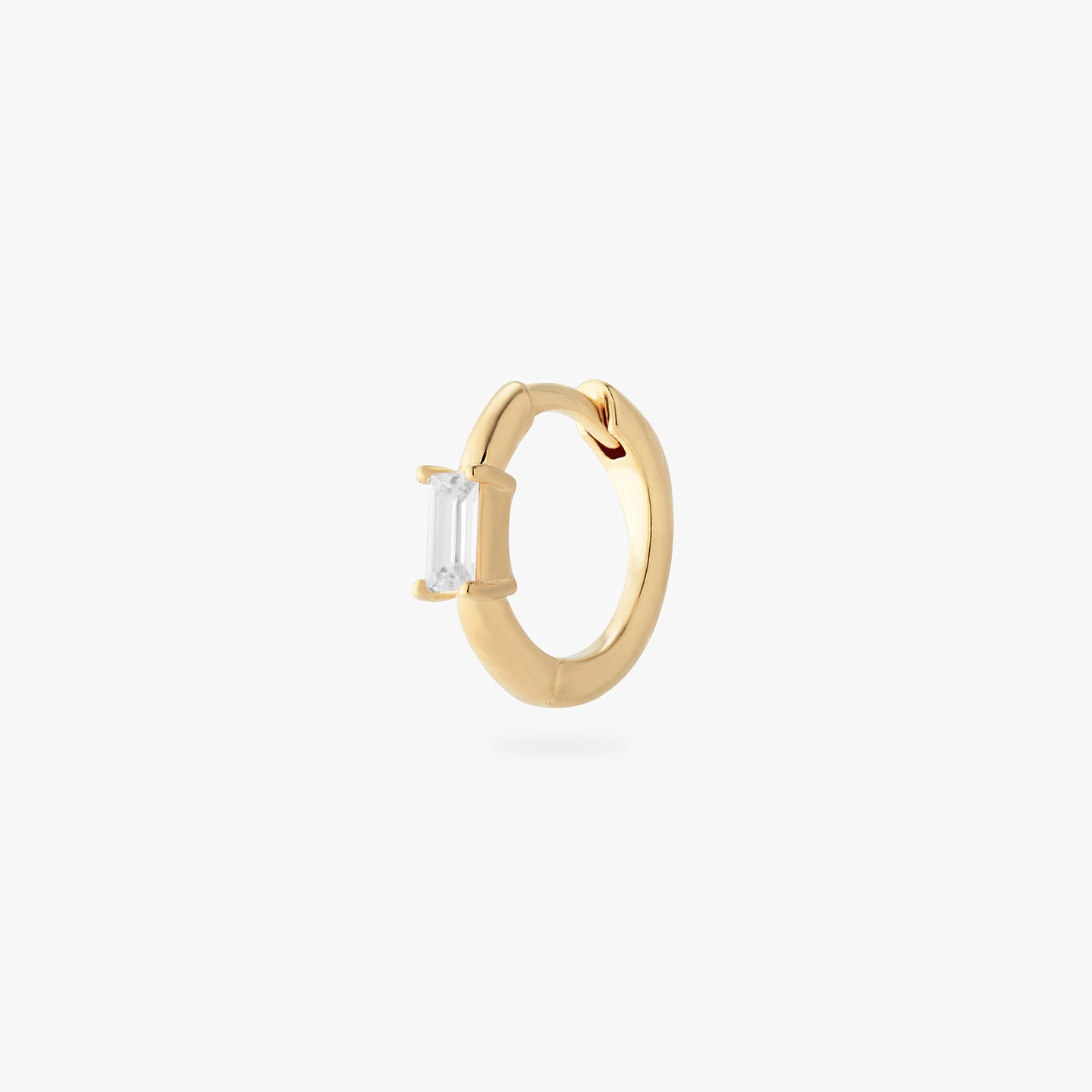 a gold small slim huggie with a clear baguette cz color:null|gold/clear