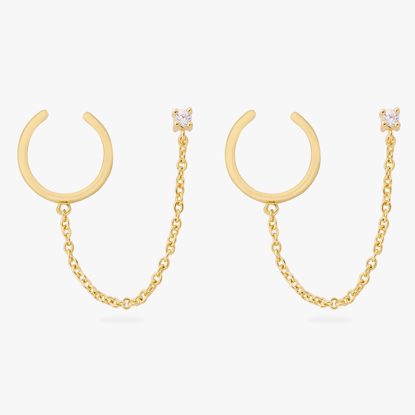 a pair of gold cz stud with a chain connecting it to a gold slim cuff [pair] color:null|gold/clear