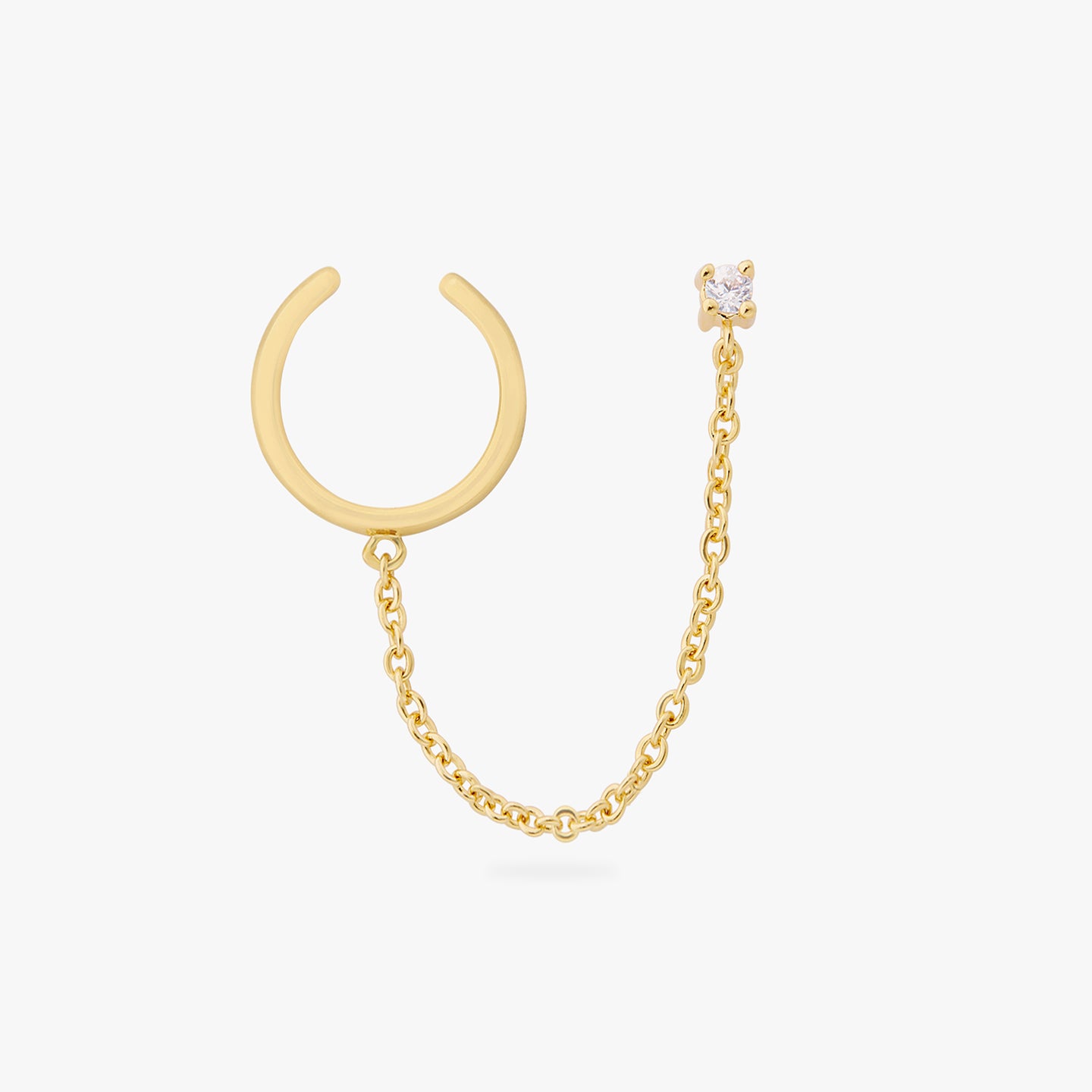 a gold cz stud with a chain connecting it to a gold slim cuff color:null|gold/clear