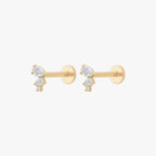 This image shows the side view of a pair of the 14k yellow gold pear cluster flatback with three clear cz stones 