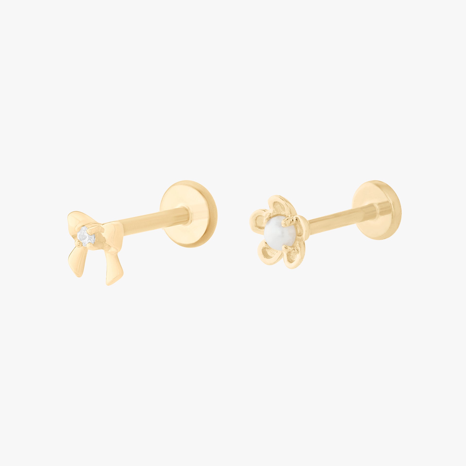 This image shows a 14k Yellow Gold set. This set includes a Gold bow flatback stud with a clear cz stone and a Gold daisy flatback stud with a pearl in the center.