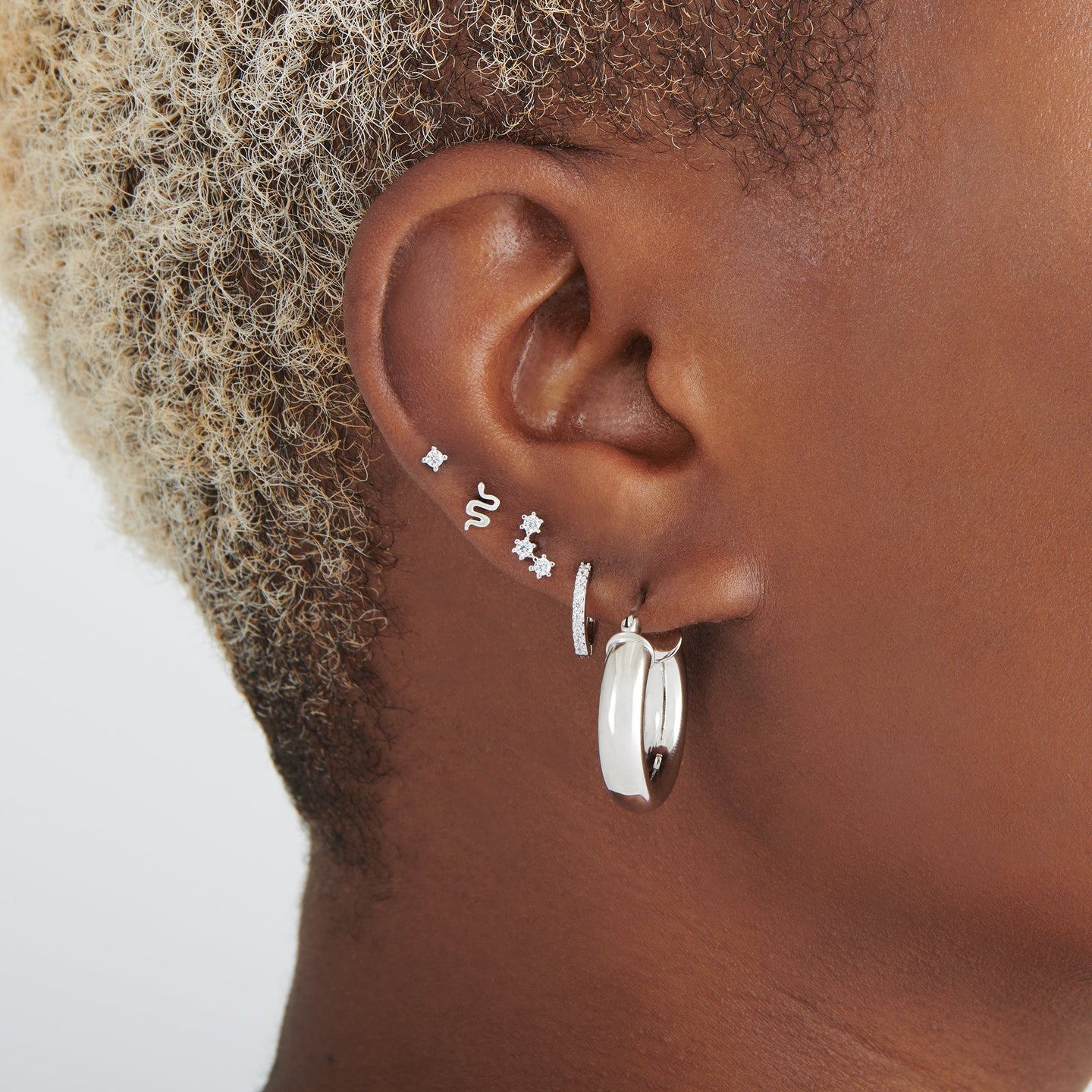 A silver cluster shaped stud with clear czs and a flatback post on ear [hover] color:null|silver/clear