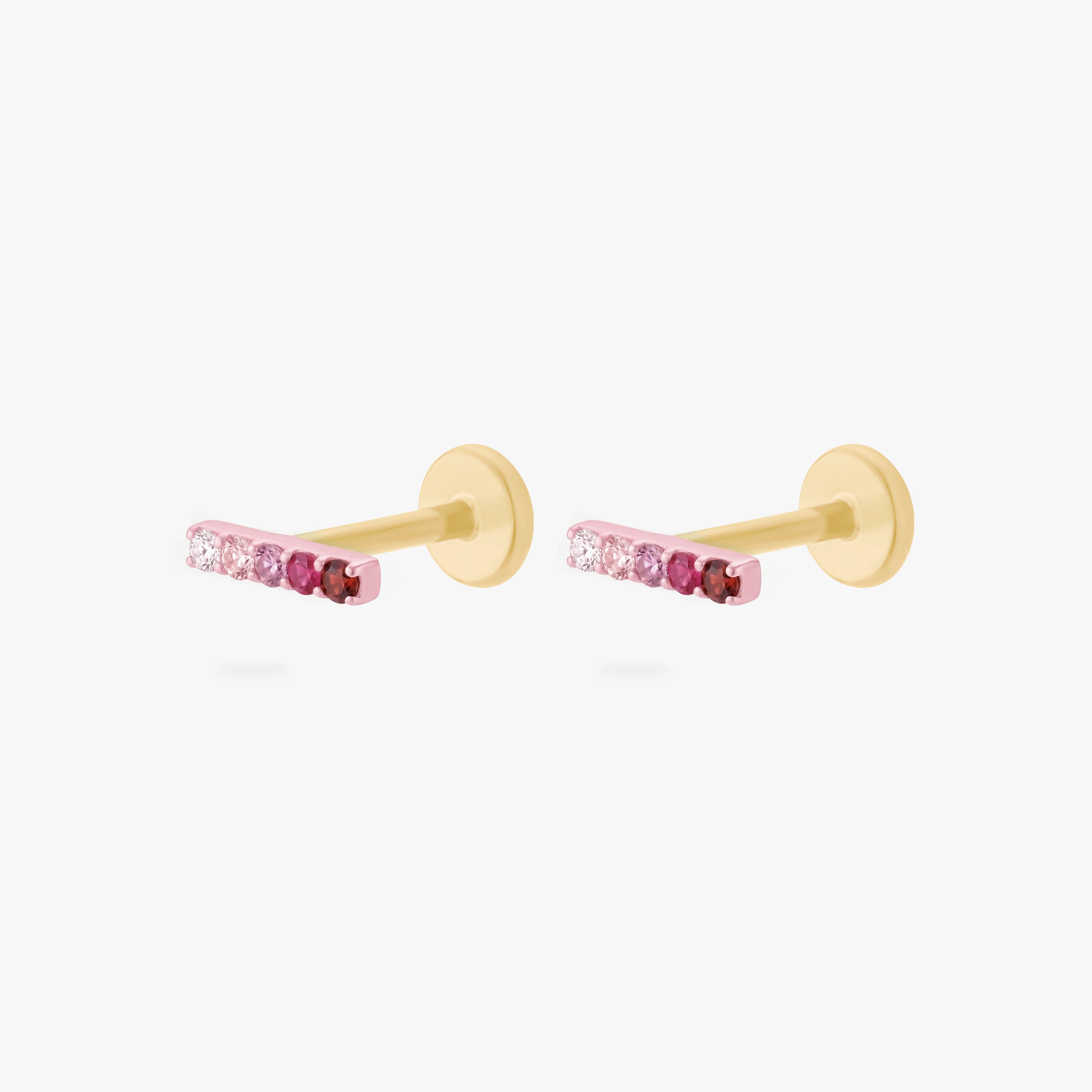 Pair of gold flatback earrings with a gradient of pink stones on a white background
