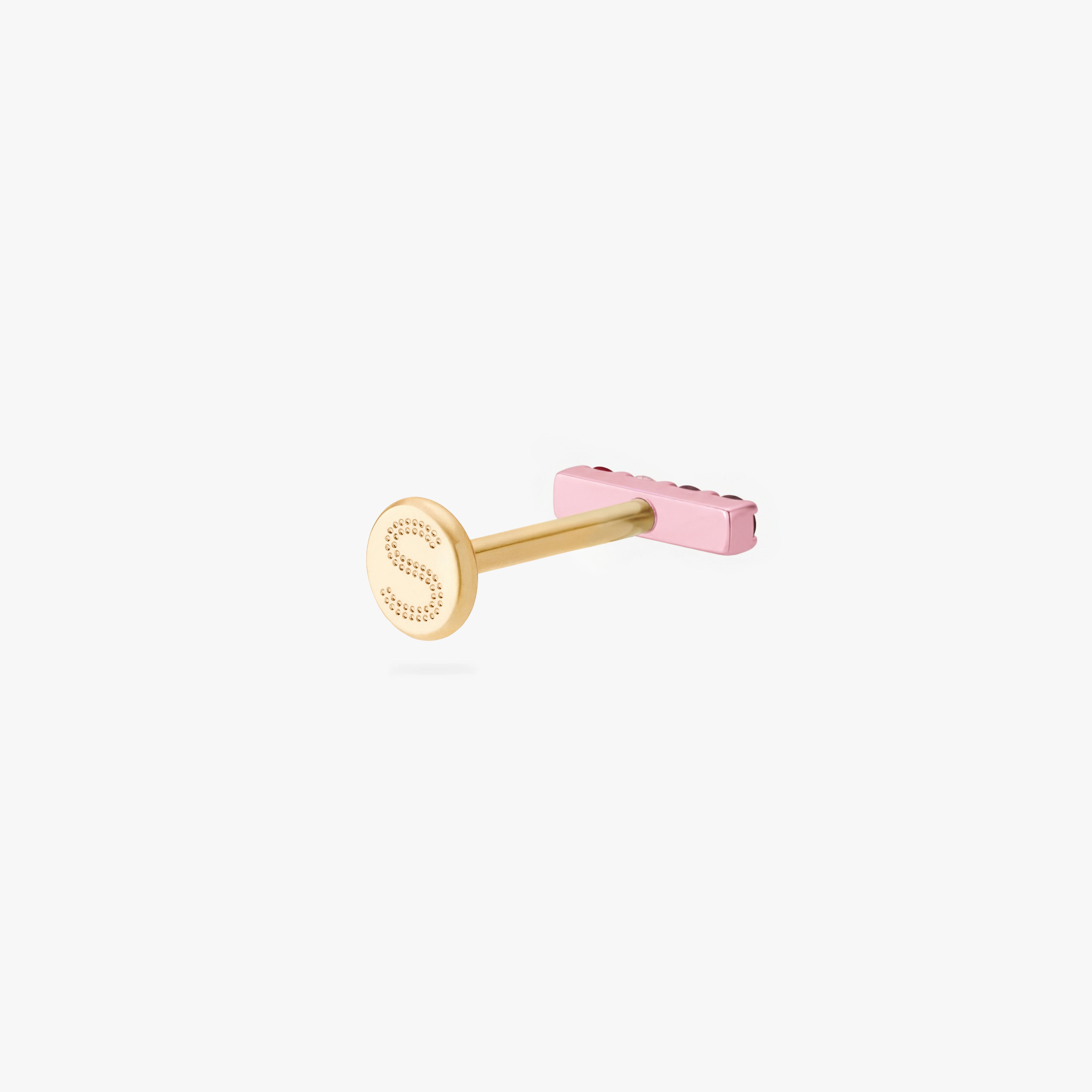 Back angle of a pink flatback stud with a gold backing with an engraved 'S'