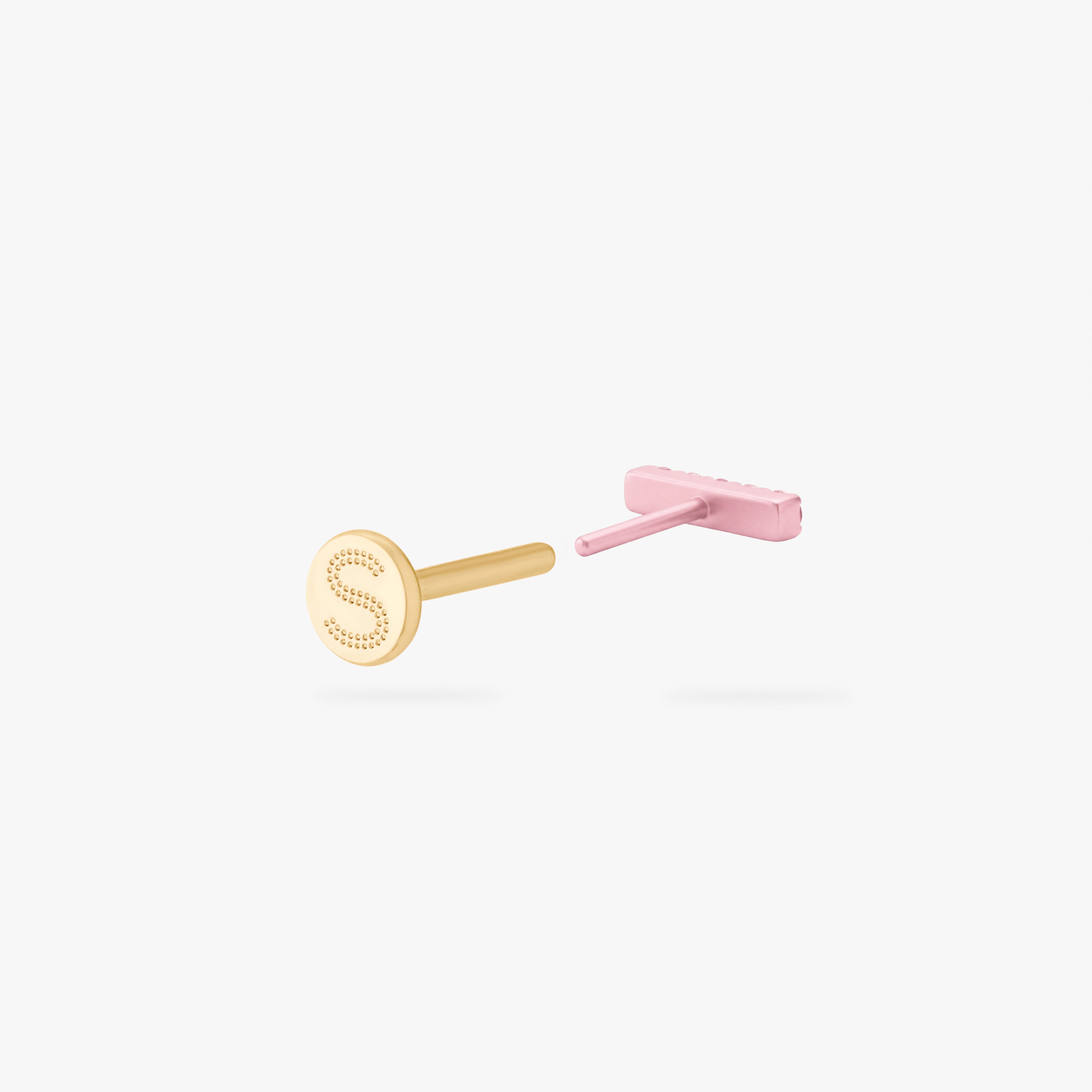 Back angle of a pink flatback stud open with a gold backing with an engraved 'S'