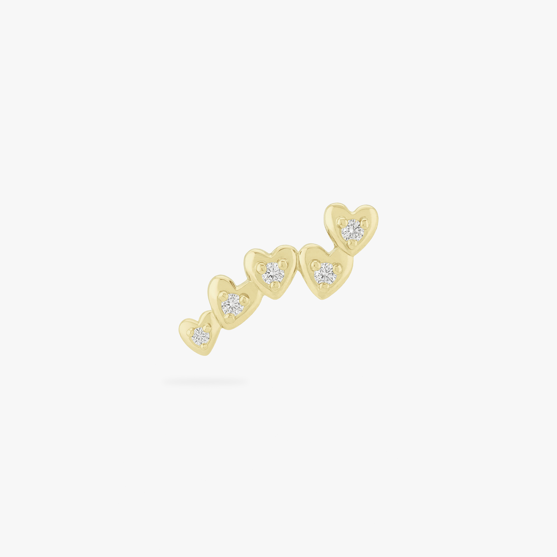 This image is a yellow anodized titanium flatback stud that features 5 hearts with crystal CZ stones in each center in a cluster against a white background.