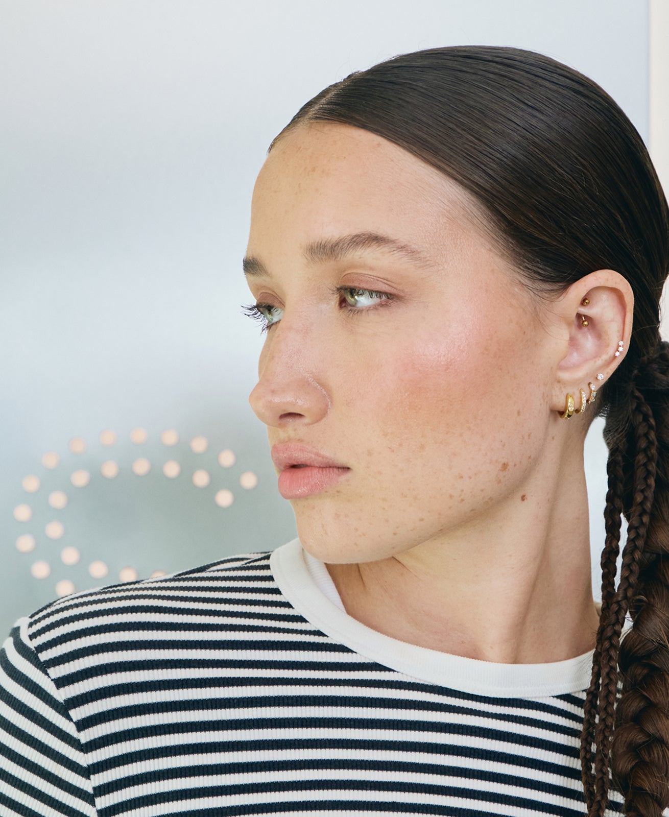 Woman with with a sparkly gold earscape