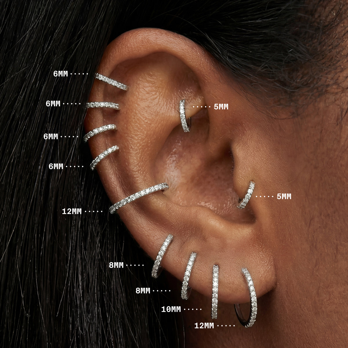 Close up ear image with all sizes of silver pave clickers, showing sizes from 5mm to 12mm