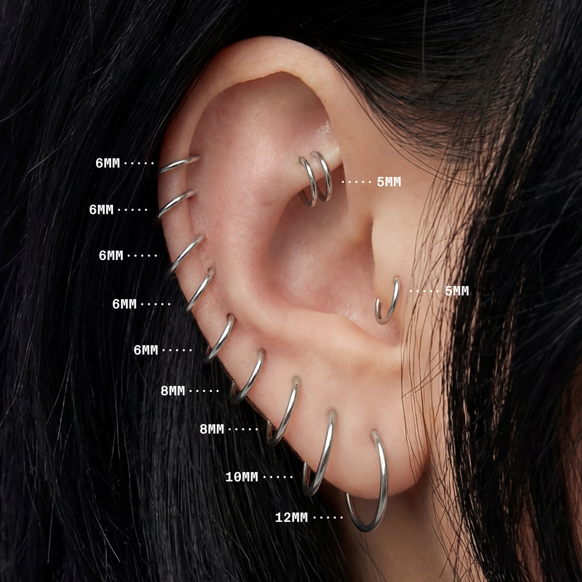 On ear image with all silver clicker sizes highlighting sizes 5mm to 12mm