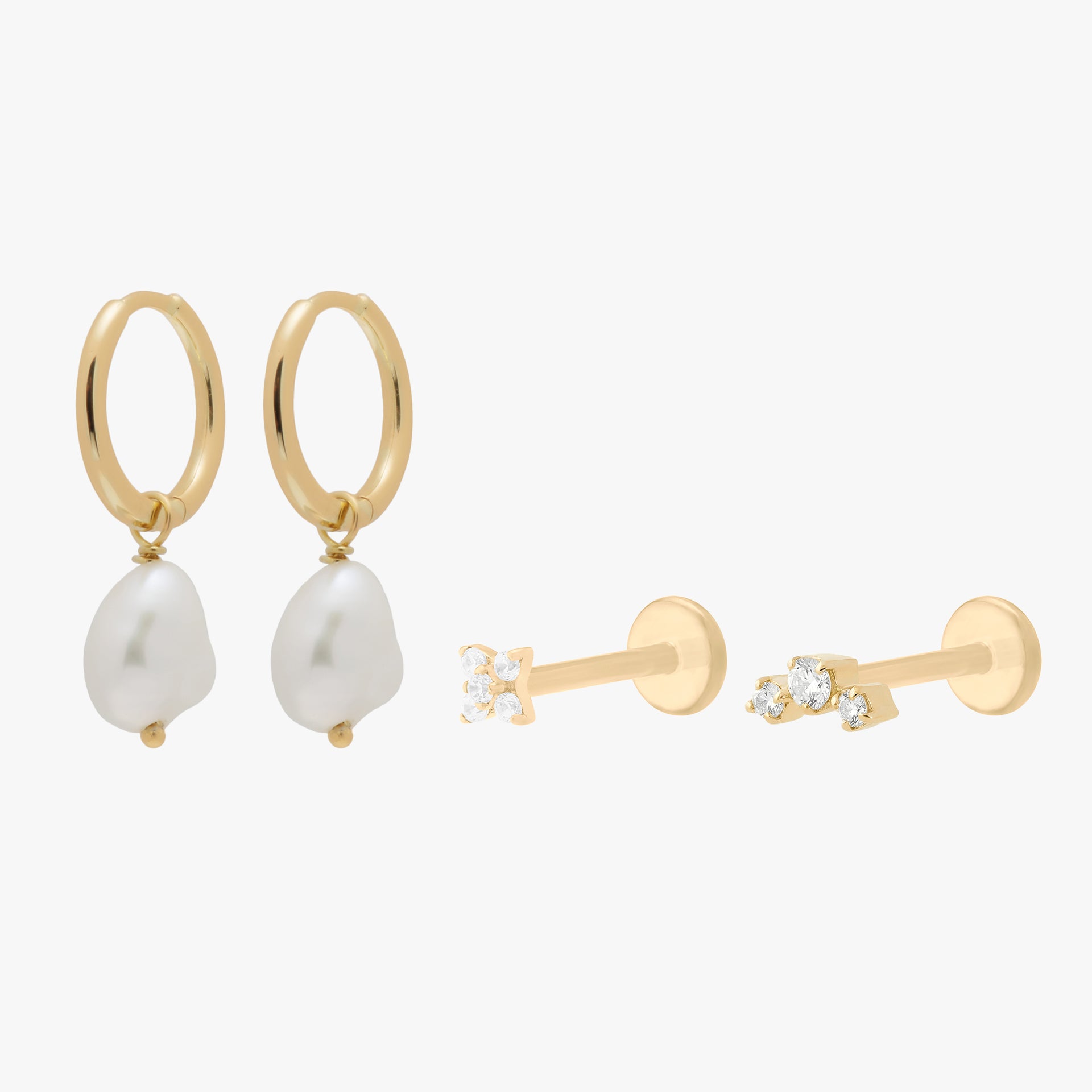 Image of the gold CBK Set which includes a pair of Baroque Pearl Huggies and two micro flatbacks with small clear cz stones - Main view