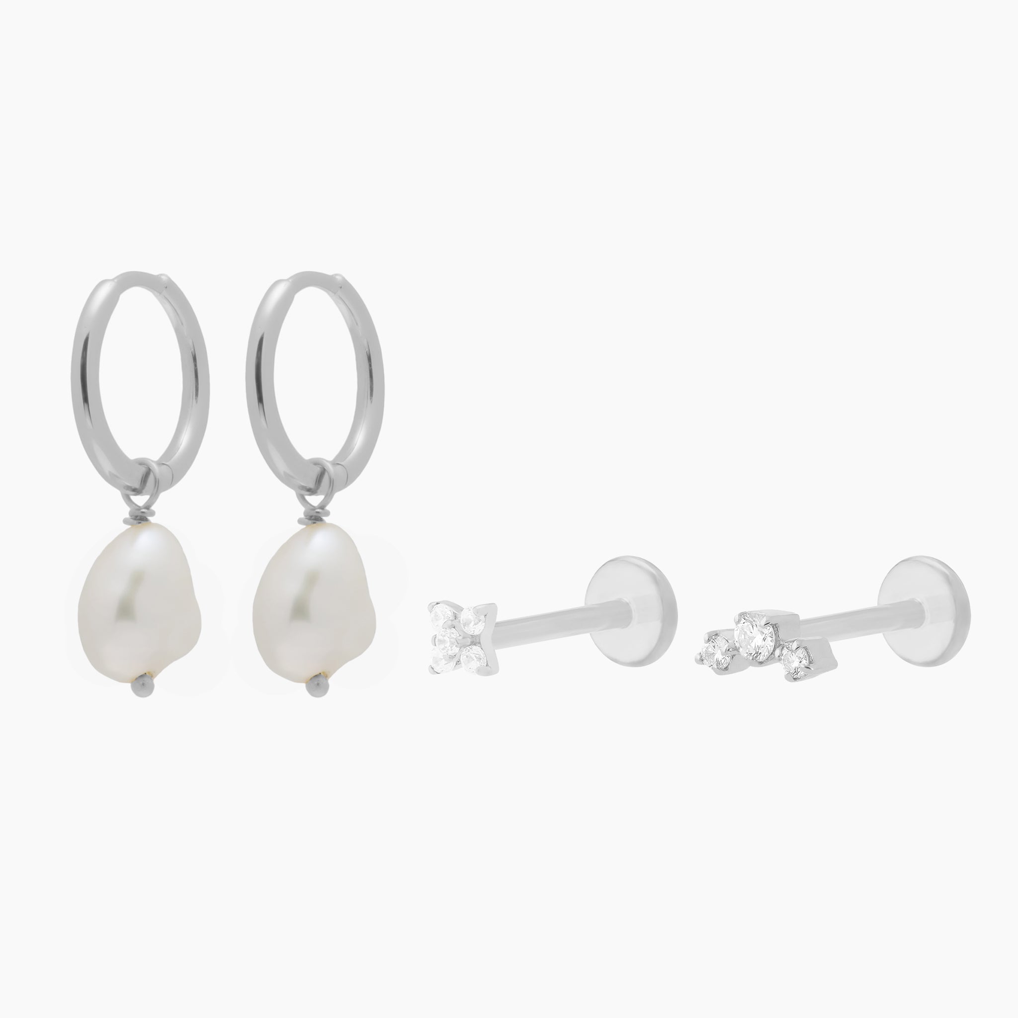 Image of the silver CBK Set which includes a pair of Baroque Pearl Huggies and two micro flatbacks with small clear cz stones - Main view