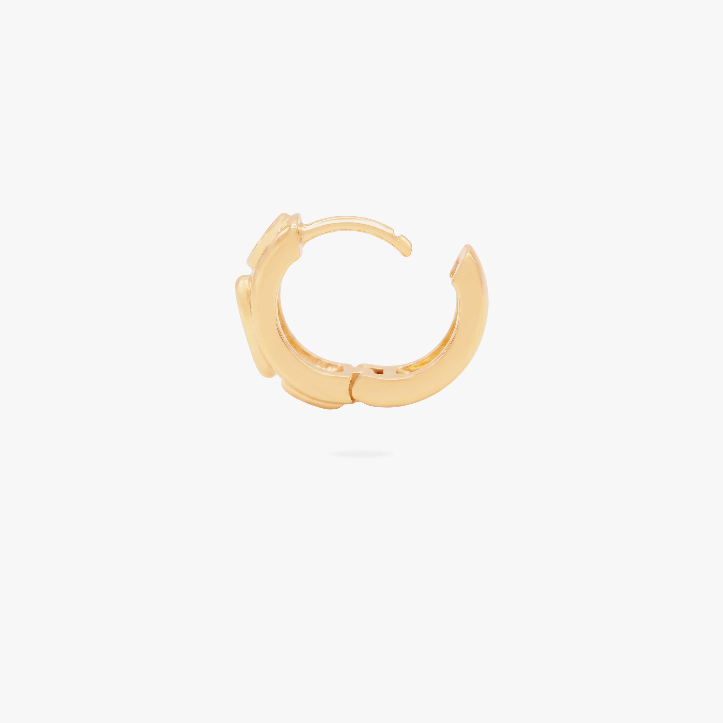 this image shows the profile view of a 14k gold plated huggie with three clear circular cz stones - Alternative view 2