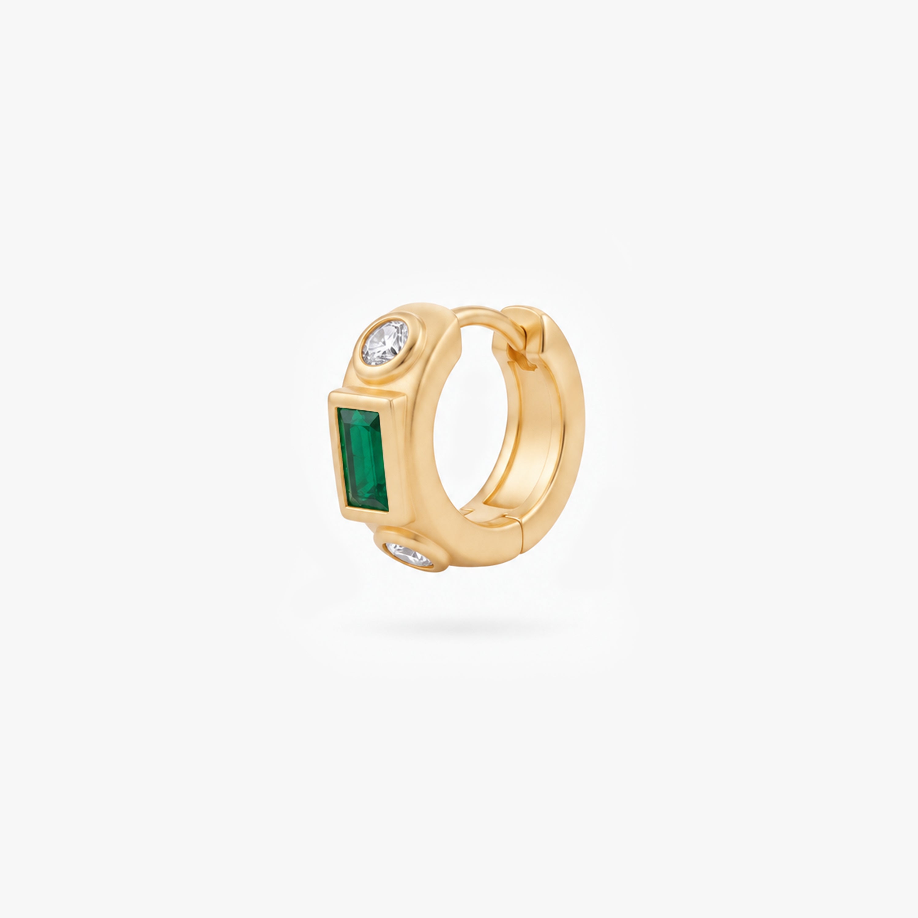 This image shows the front view of a 14k gold plated huggie with three cz stones. One green square in the middle and two clear circular stones on the outside. - Main view