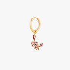  This image shows a 14k gold plated huggie earring with a crab charm with red spots. 