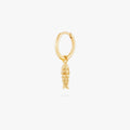 This image shows a 14k gold plated huggie with a dangling fish charm 