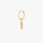 This image shows a 14k gold plated huggie with a dangling fish charm 