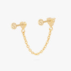 Anodized titanium gold chain connector earring flat back featuring a heart CZ stud and another heart stud linked by a delicate gold chain. This image shows a back view of the earring.
