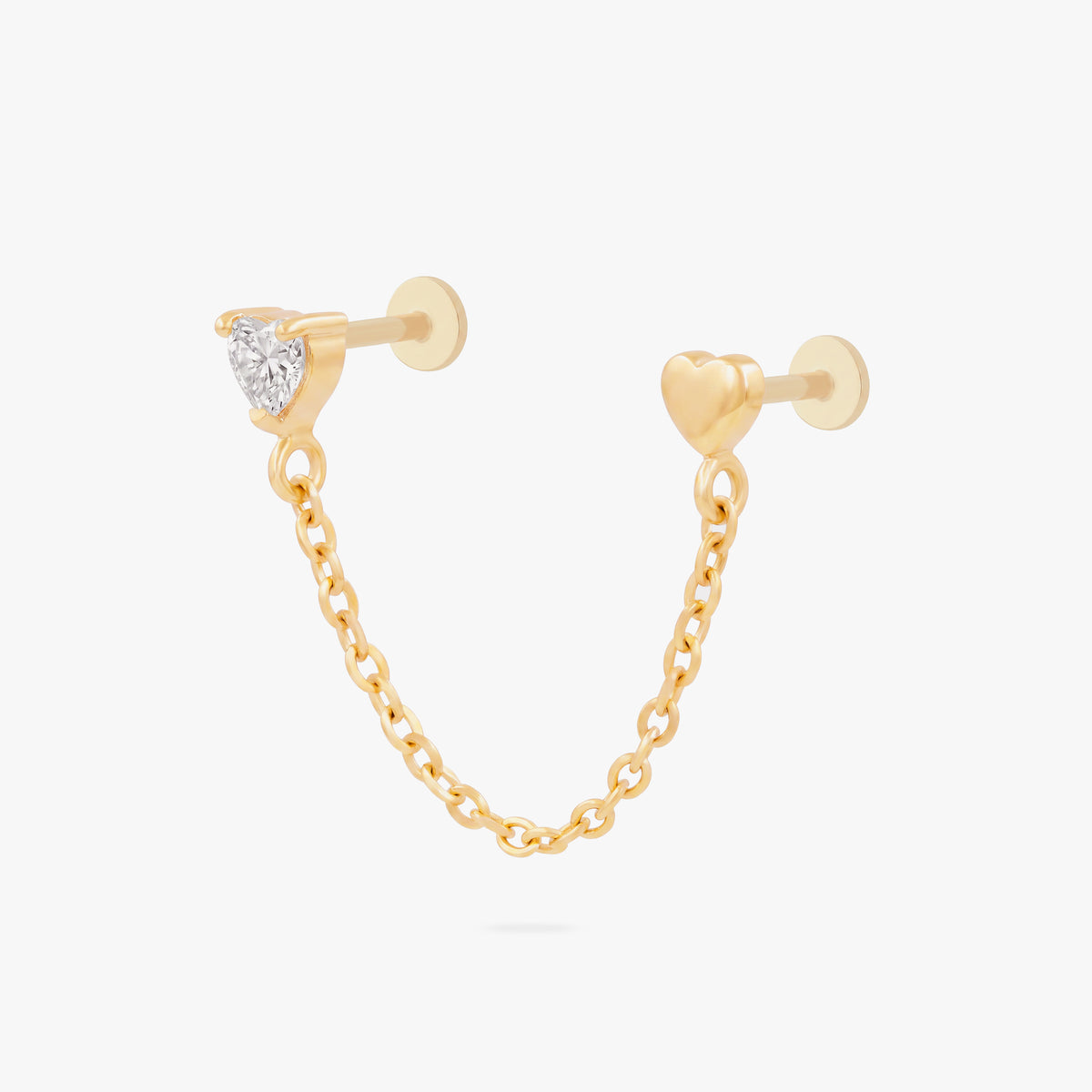 Anodized titanium gold chain connector earring flat back featuring a heart CZ stud and another heart stud linked by a delicate gold chain.