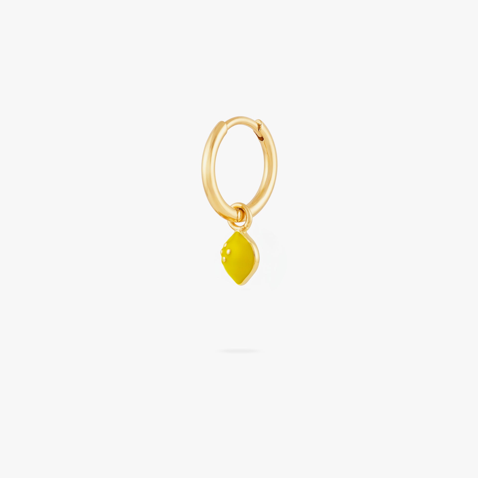 This image shows a 14k gold plated huggie with a yellow lemon charm.