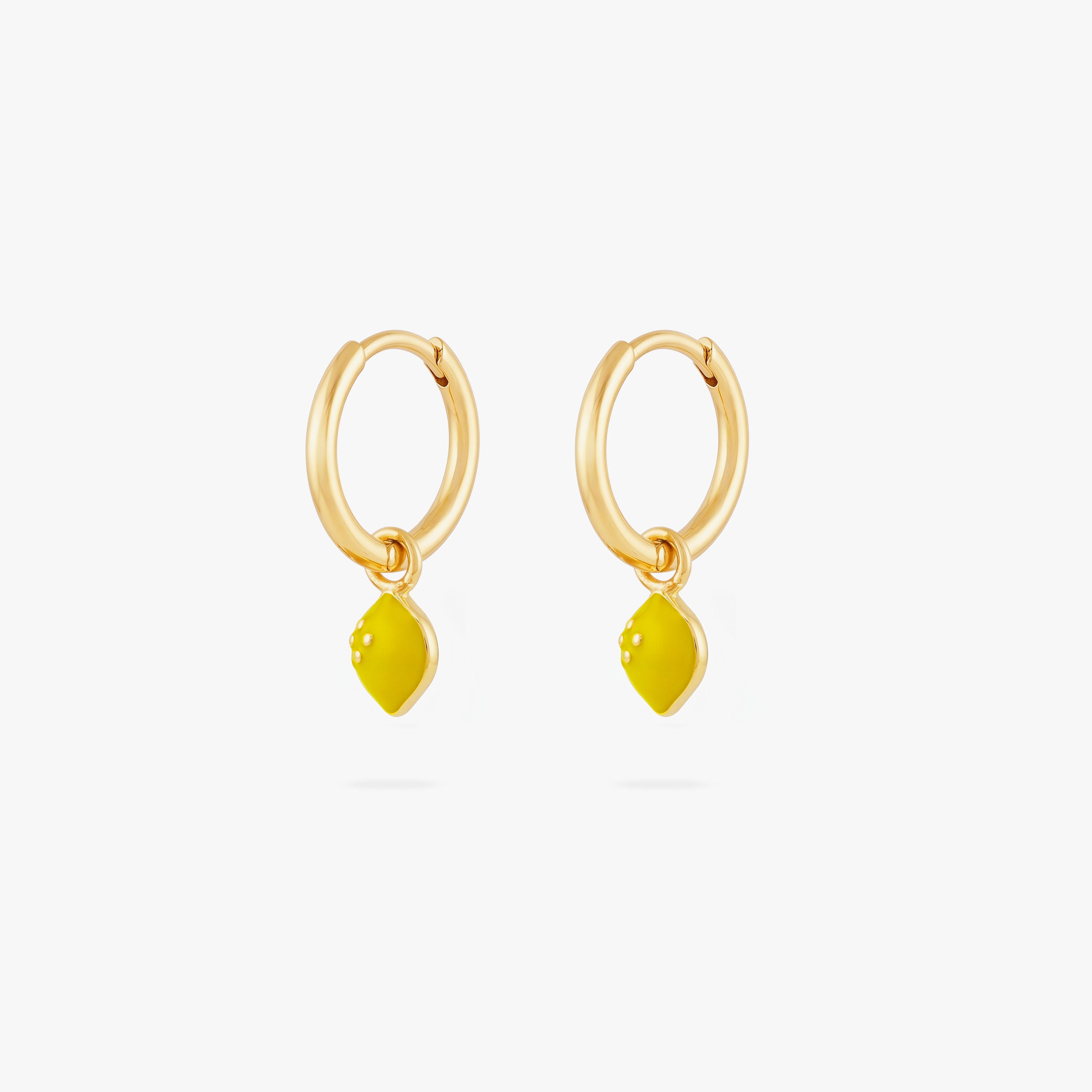 This image shows a  pair of 14k gold plated huggies with yellow lemon charms.