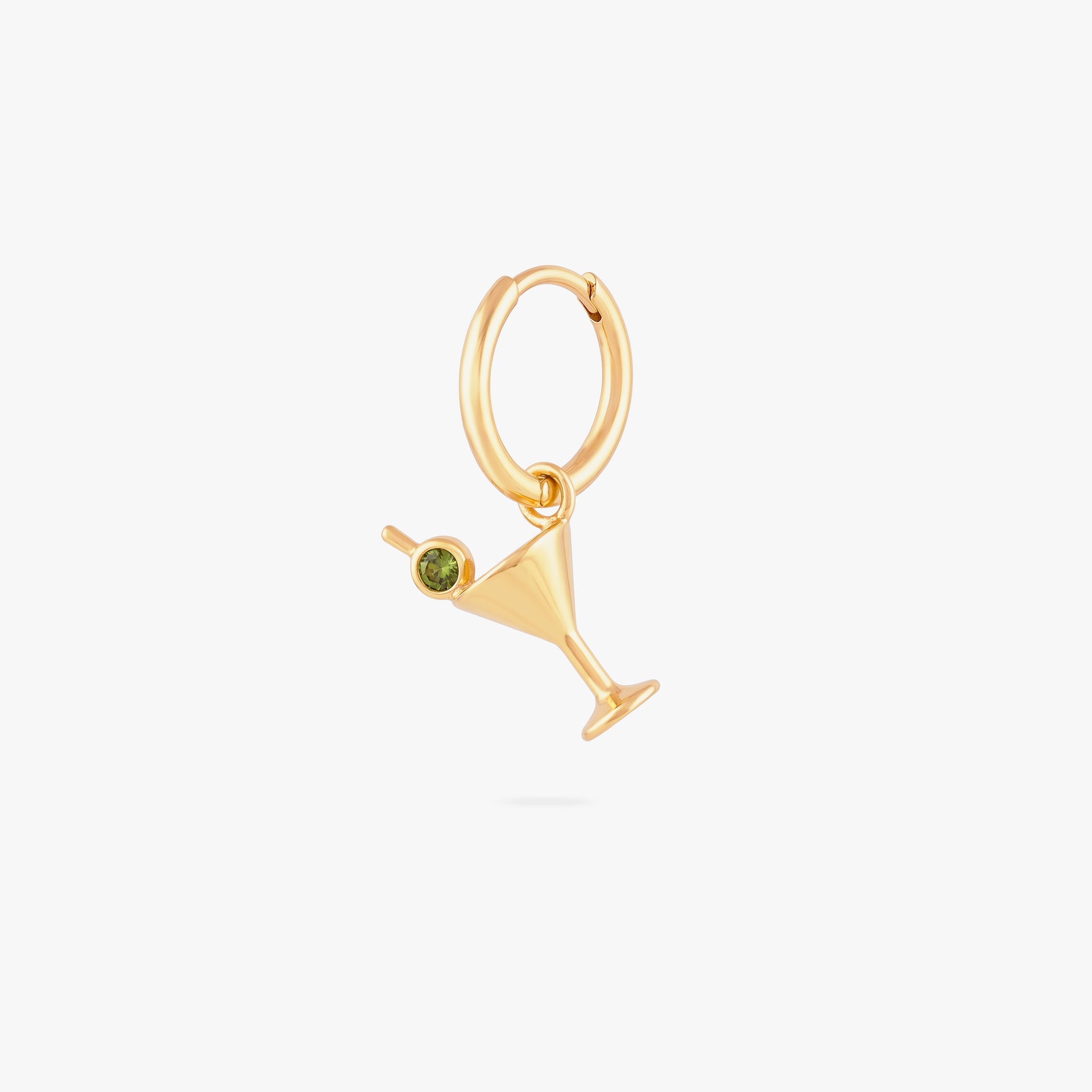 this image shows a 14k gold plated huggie with a martini glass charm with a green gemstone.
