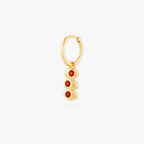 this image shows a 14k gold plated huggie with three olives with a red stone in the middle of each olive. 