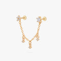 This is an anodized gold titanium chained flatback stud with two flatback posts. Each flatback stud is a clear star CZ, and there is a chain with three clear CZ stones that connect the two earrings.