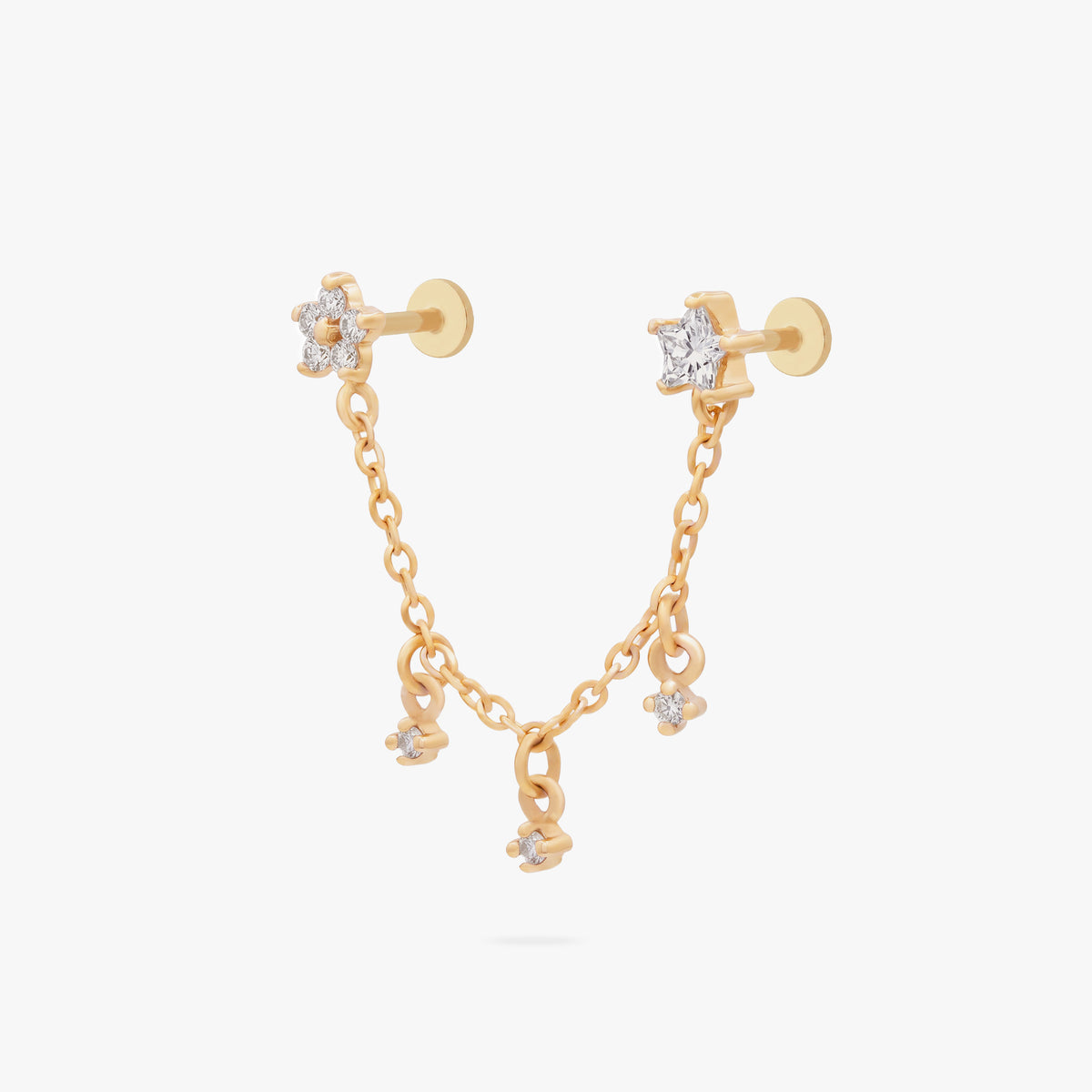 This is an anodized gold titanium chained flatback stud with two flatback posts. Each flatback stud is a clear star CZ, and there is a chain with three clear CZ stones that connect the two earrings.