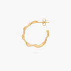 This image shows the profile view of a 14k gold plated hoop with an organic shape around the hoop 