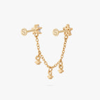 This is an anodized gold titanium chained flatback stud with two flatback posts. Each flatback stud is a clear star CZ, and there is a chain with three clear CZ stones that connect the two earrings. This image shows the back view of the earring.