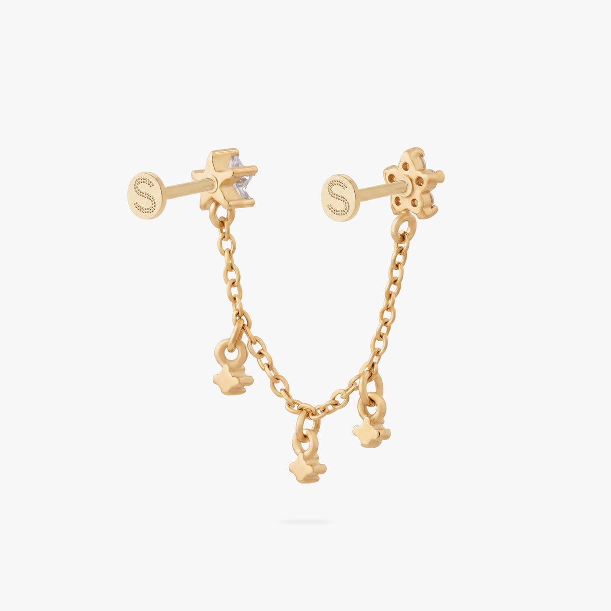 This is an anodized gold titanium chained flatback stud with two flatback posts. Each flatback stud is a clear star CZ, and there is a chain with three clear CZ stones that connect the two earrings. This image shows the back view of the earring.