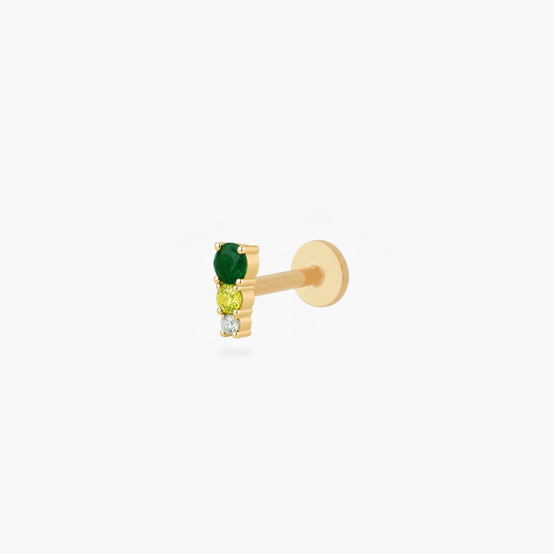 This image shows a side angle of a Golden titanium flatback with three cz stones. the top one is a dark green, the middle a light green and the bottom cz is clear. - Main view